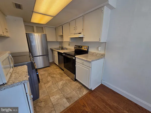a view of backyard with wooden floor and fence