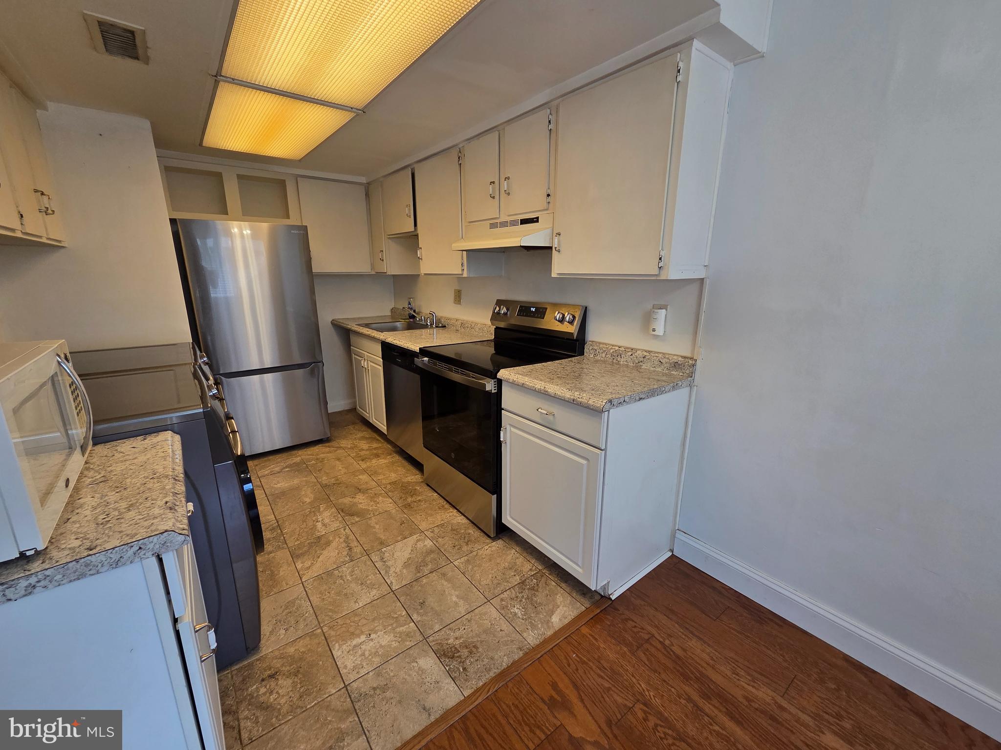 1729 Leisure Way Crofton, MD 21114 - Photo 17 of 20 a kitchen with stainless steel appliances granite countertop a refrigerator sink and stove