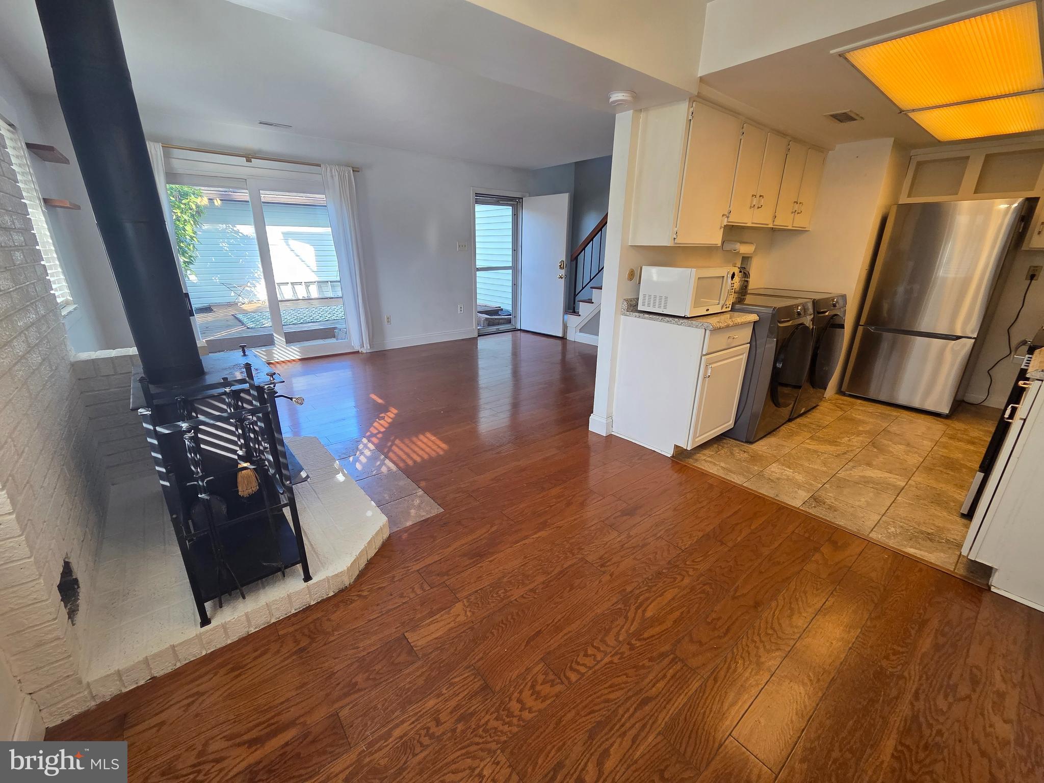 1729 Leisure Way Crofton, MD 21114 - Photo 10 of 20 a kitchen with stainless steel appliances granite countertop a refrigerator a stove and a sink with wooden floor