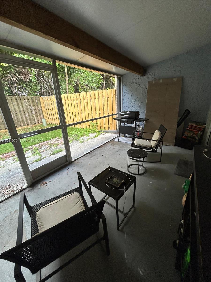 7402 Northwest 75th Street Tamarac, FL 33321 - Photo 14 of 38 a living room with furniture and a large window