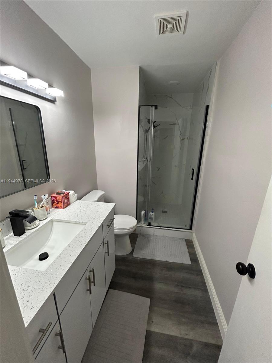 7402 Northwest 75th Street Tamarac, FL 33321 - Photo 15 of 38 a bathroom with a sink a toilet and shower