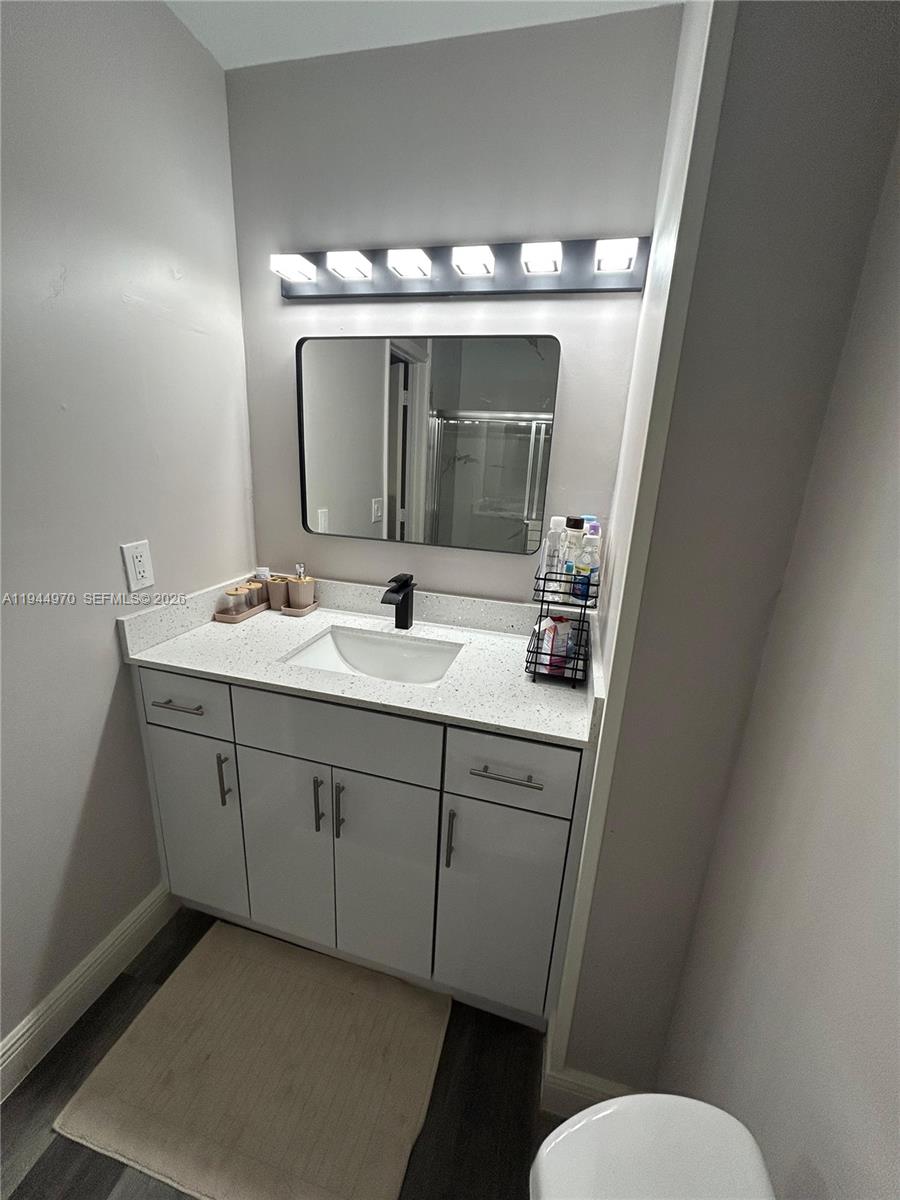 7402 Northwest 75th Street Tamarac, FL 33321 - Photo 18 of 38 a bathroom with a sink and mirror