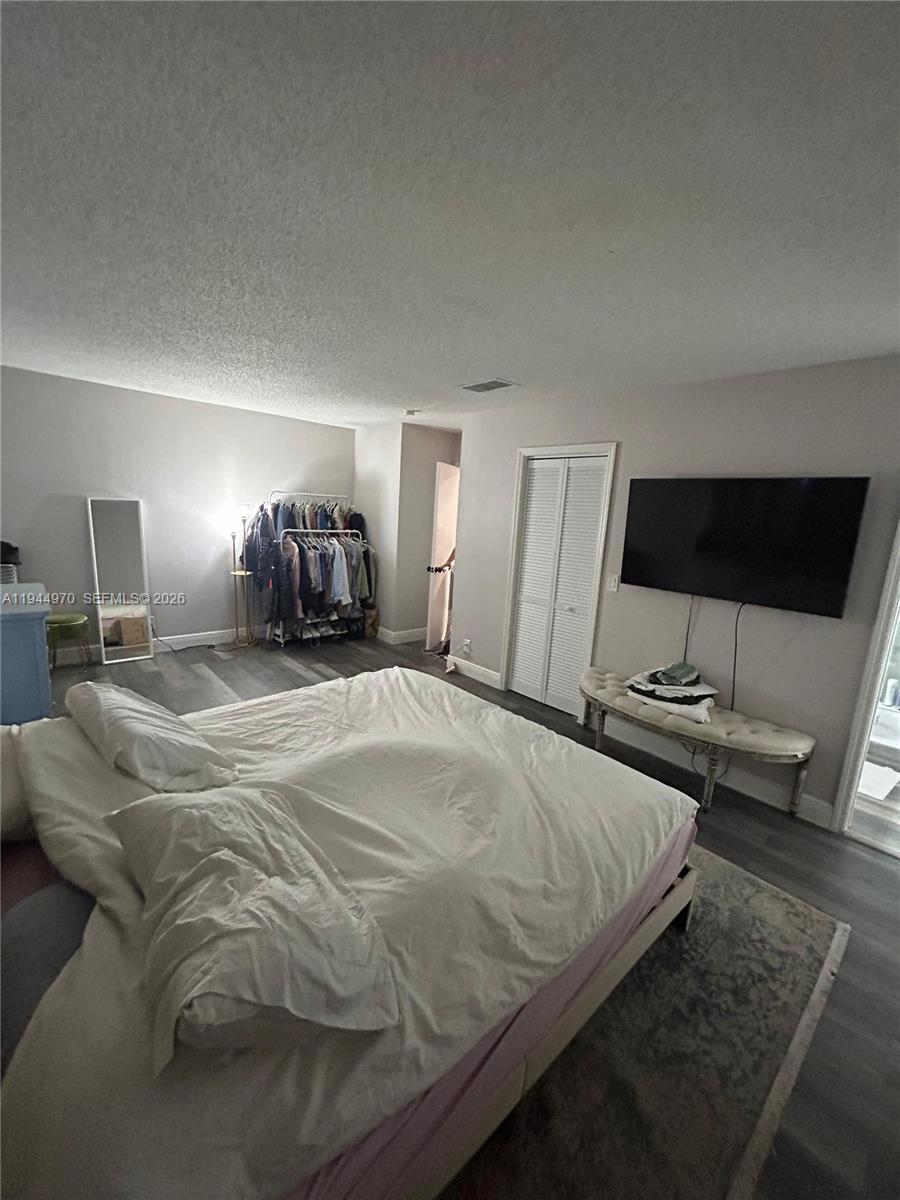 7402 Northwest 75th Street Tamarac, FL 33321 - Photo 19 of 38 a spacious bedroom with a bed and a flat screen tv