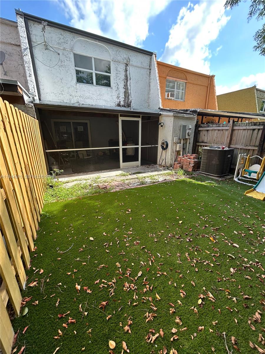 7402 Northwest 75th Street Tamarac, FL 33321 - Photo 2 of 38 a front view of a house with a yard