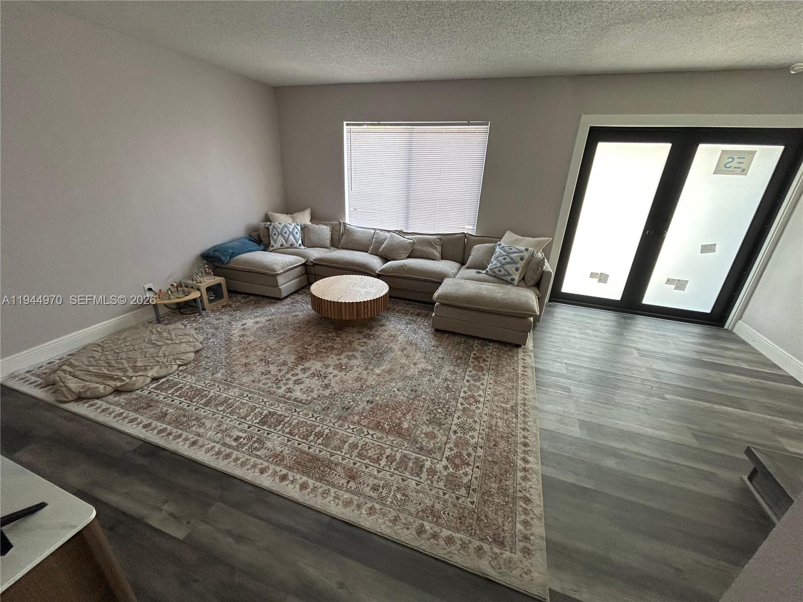 7402 Northwest 75th Street Tamarac, FL 33321 - Photo 22 of 38 a living room with furniture and wooden floor