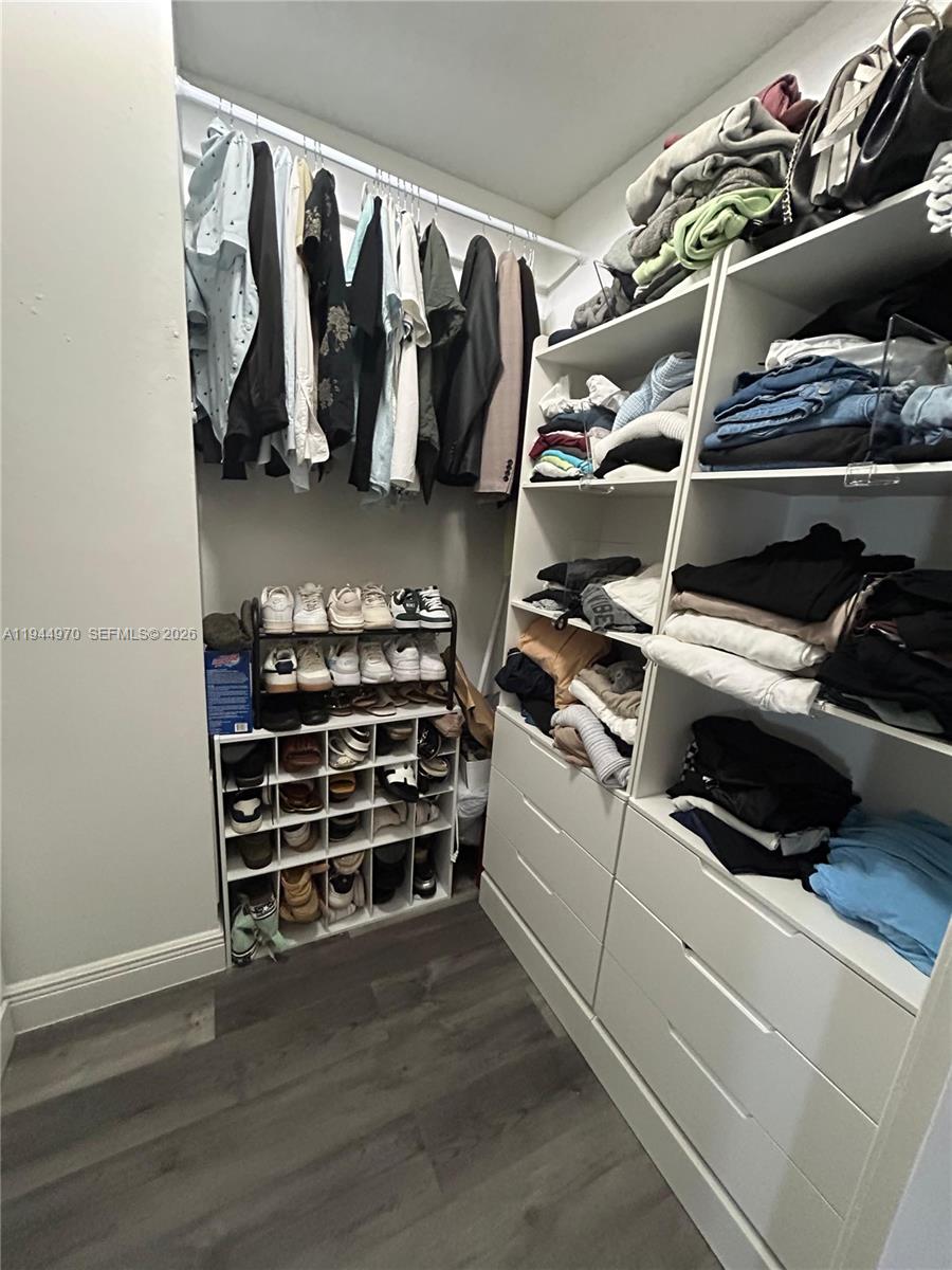 7402 Northwest 75th Street Tamarac, FL 33321 - Photo 23 of 38 a view of walk in closet with clothes and shoes