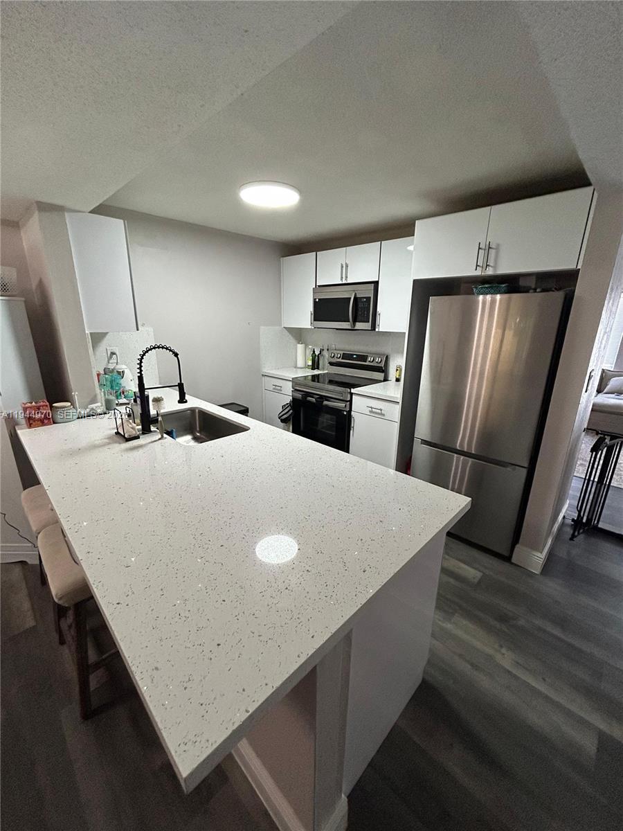 7402 Northwest 75th Street Tamarac, FL 33321 - Photo 26 of 38 a kitchen with stainless steel appliances a refrigerator and a stove