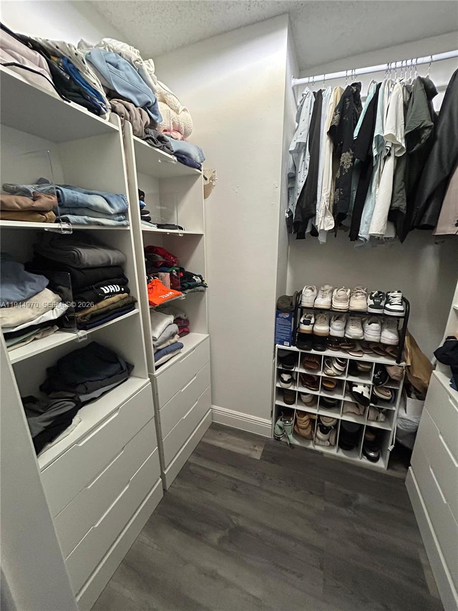 7402 Northwest 75th Street Tamarac, FL 33321 - Photo 27 of 38 a view of walk in closet with clothes and shoes
