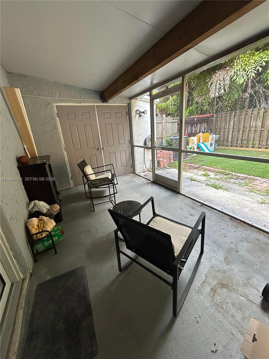 7402 Northwest 75th Street Tamarac, FL 33321 - Photo 28 of 38 a living room with furniture and a floor to ceiling window