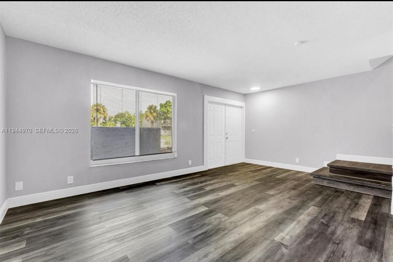 7402 Northwest 75th Street Tamarac, FL 33321 - Photo 32 of 38 a view of room with window and wooden floor
