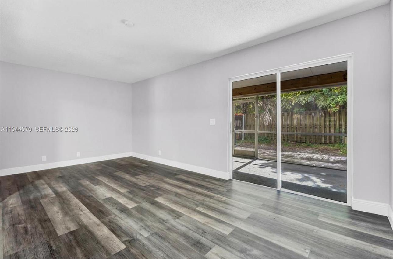 7402 Northwest 75th Street Tamarac, FL 33321 - Photo 38 of 38 a view of wooden floor and cabinet in a room