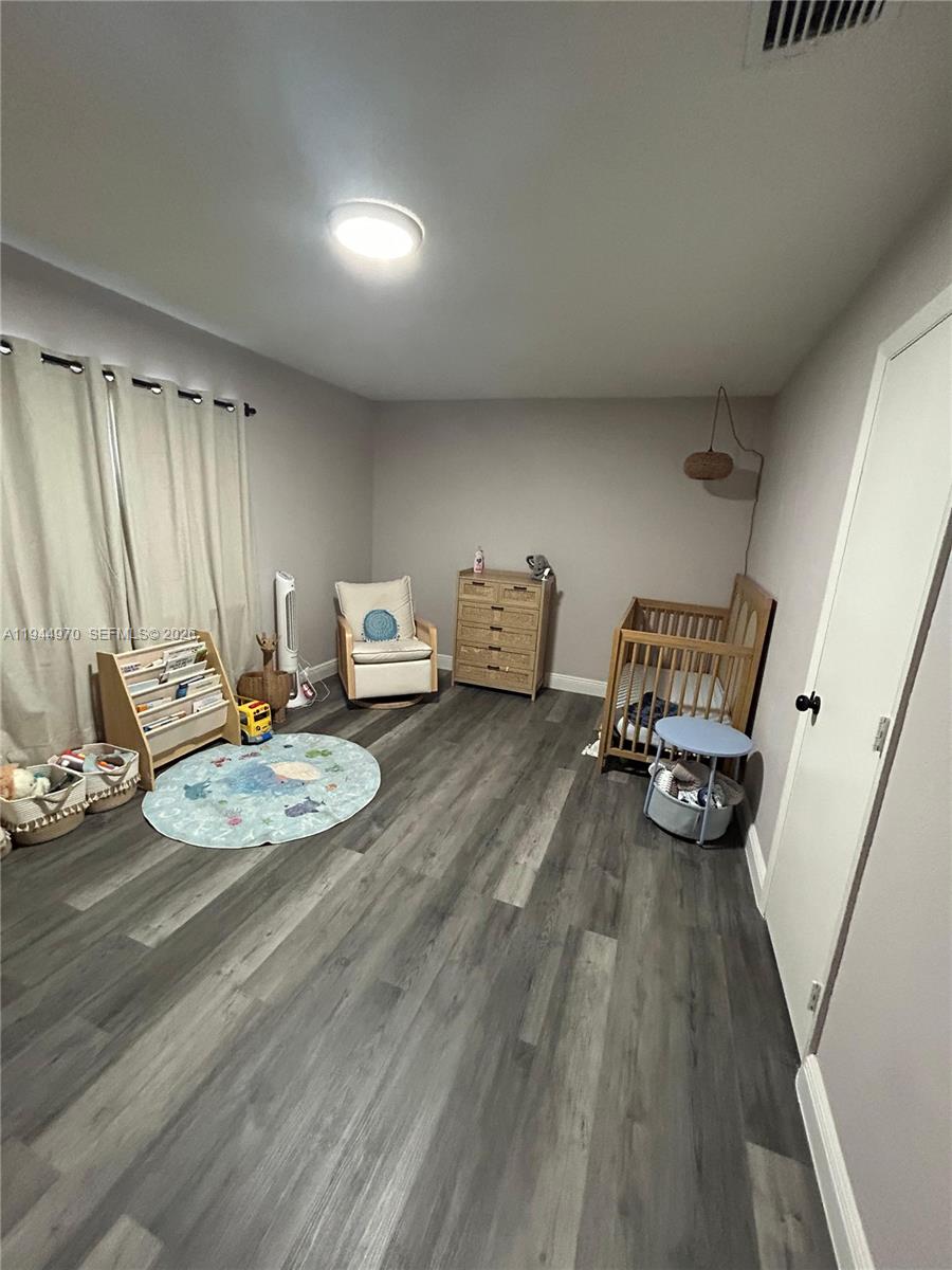 7402 Northwest 75th Street Tamarac, FL 33321 - Photo 6 of 38 a view of a room with wooden floor furniture and windows