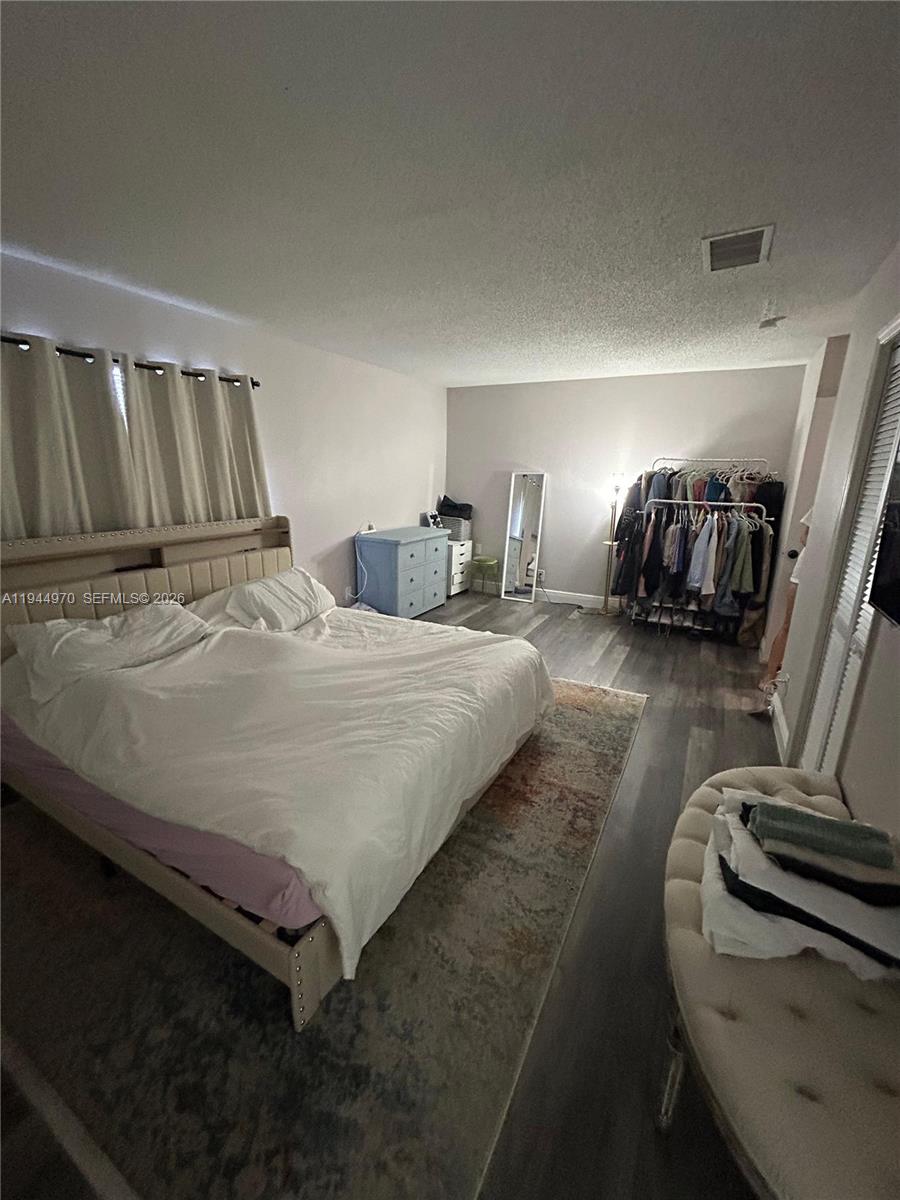 7402 Northwest 75th Street Tamarac, FL 33321 - Photo 8 of 38 a bedroom with bed and a couch