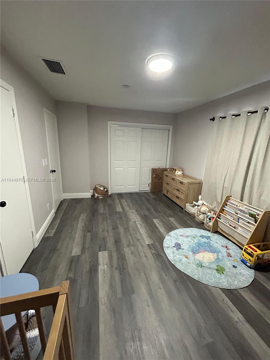 7402 Northwest 75th Street Tamarac, FL 33321 - Photo 9 of 38 a living room with furniture and a wooden floor