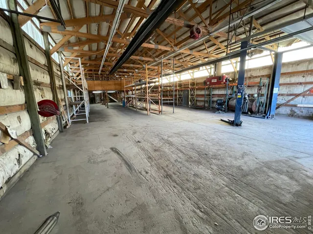 a view of empty room with wooden ceiling