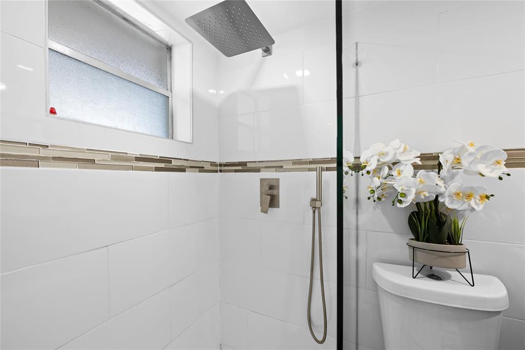 471 North Pine Island Road, Unit 302D Plantation, FL 33324 - Photo 12 of 23 a bathroom with a shower and a mirror