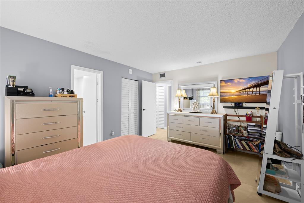 471 North Pine Island Road, Unit 302D Plantation, FL 33324 - Photo 13 of 23 a bedroom with a bed and furniture