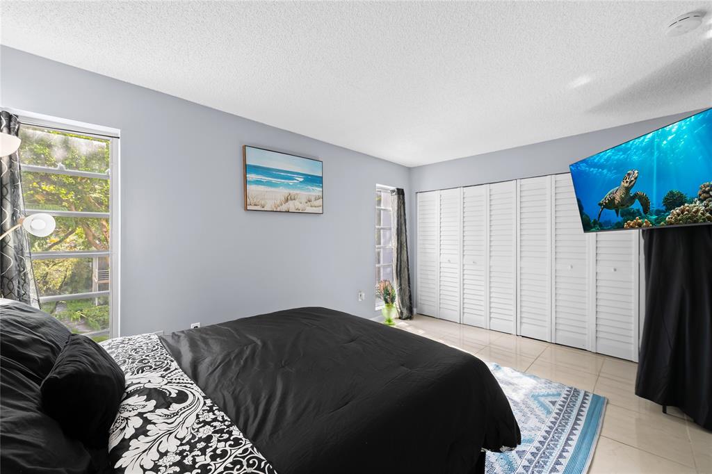 471 North Pine Island Road, Unit 302D Plantation, FL 33324 - Photo 14 of 23 a bedroom with a bed and a window