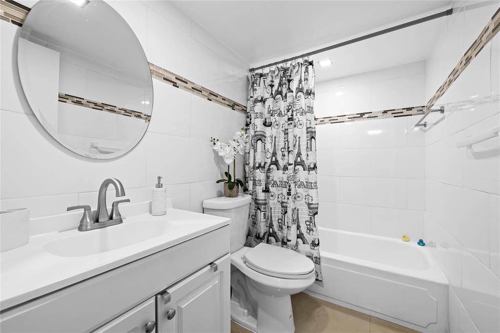471 North Pine Island Road, Unit 302D Plantation, FL 33324 - Photo 16 of 23 a bathroom with a sink a toilet and a mirror