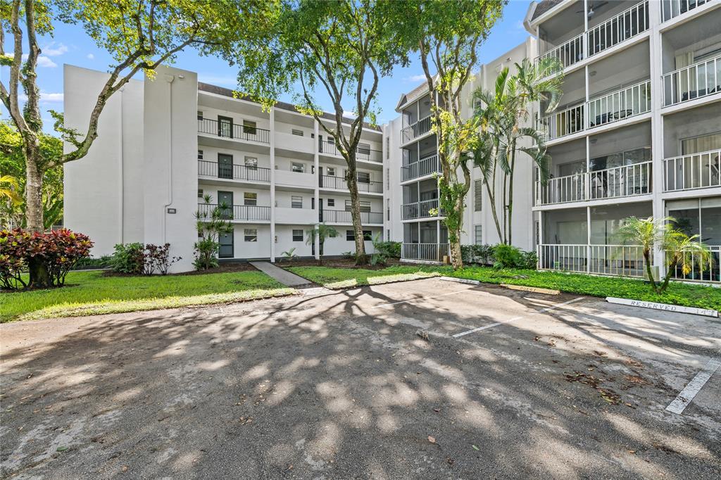 471 North Pine Island Road, Unit 302D Plantation, FL 33324 - Photo 21 of 23 a view of a building with a yard