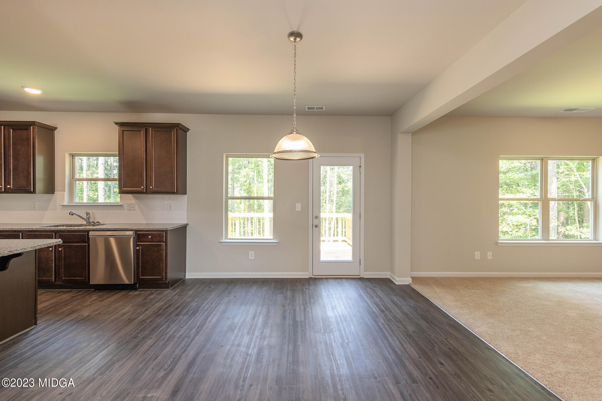 155 Cherokee Rose Drive Jackson, GA 30233 - Photo 13 of 32 a view of an empty room with window and wooden floor