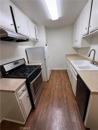 a kitchen with wooden floors and a stove