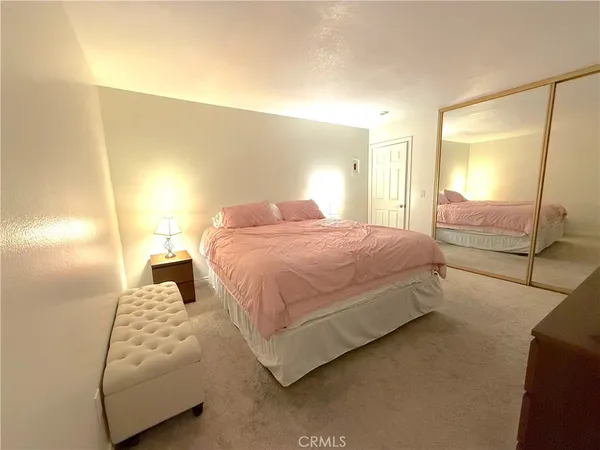 a bedroom with a bed and lamp