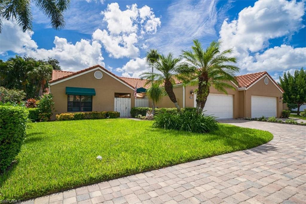 811 Reef Point Circle, Unit 90 Naples, FL 34108 - Photo 1 of 28 a front view of a house with garden