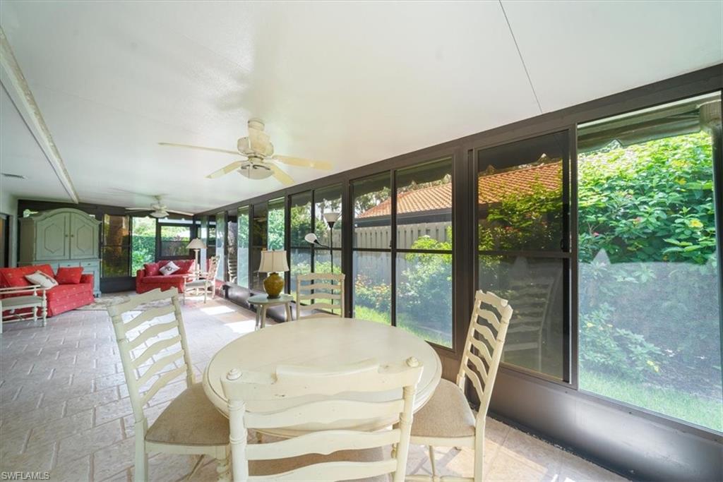811 Reef Point Circle, Unit 90 Naples, FL 34108 - Photo 14 of 28 a view of a dining room with furniture large windows and outside view