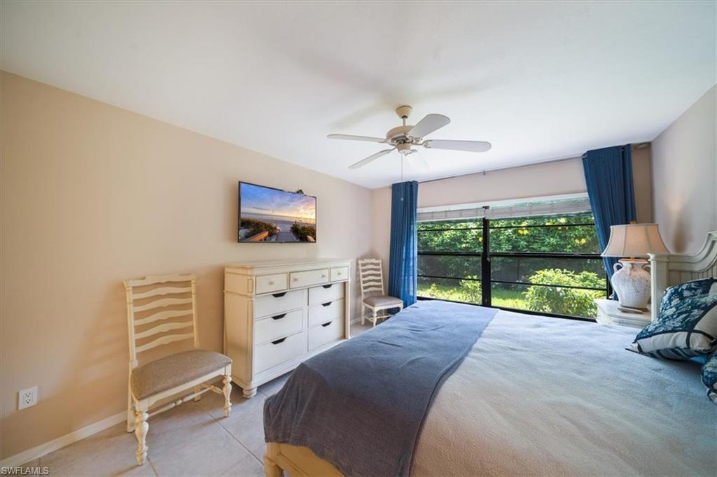 811 Reef Point Circle, Unit 90 Naples, FL 34108 - Photo 18 of 28 a bed room with a bed and a television