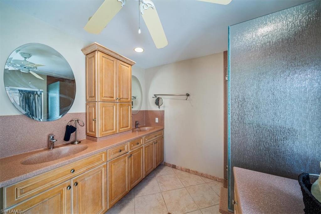 811 Reef Point Circle, Unit 90 Naples, FL 34108 - Photo 19 of 28 a bathroom with a sink and a mirror