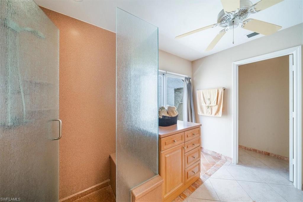 811 Reef Point Circle, Unit 90 Naples, FL 34108 - Photo 20 of 28 a hallway with cabinets and wooden floor