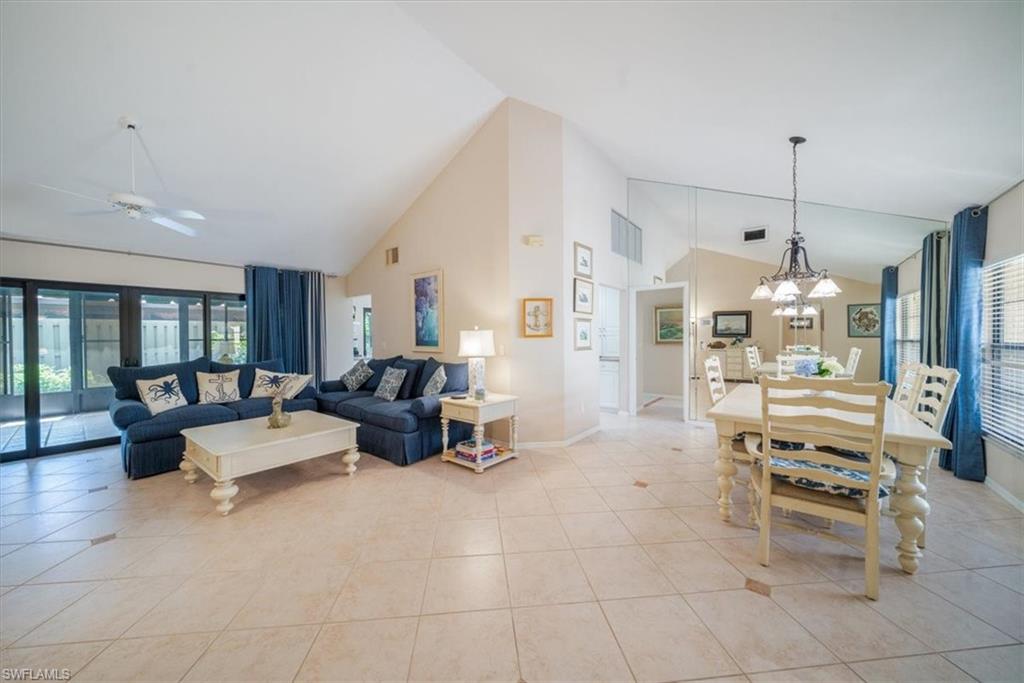 811 Reef Point Circle, Unit 90 Naples, FL 34108 - Photo 2 of 28 a living room with furniture and a chandelier