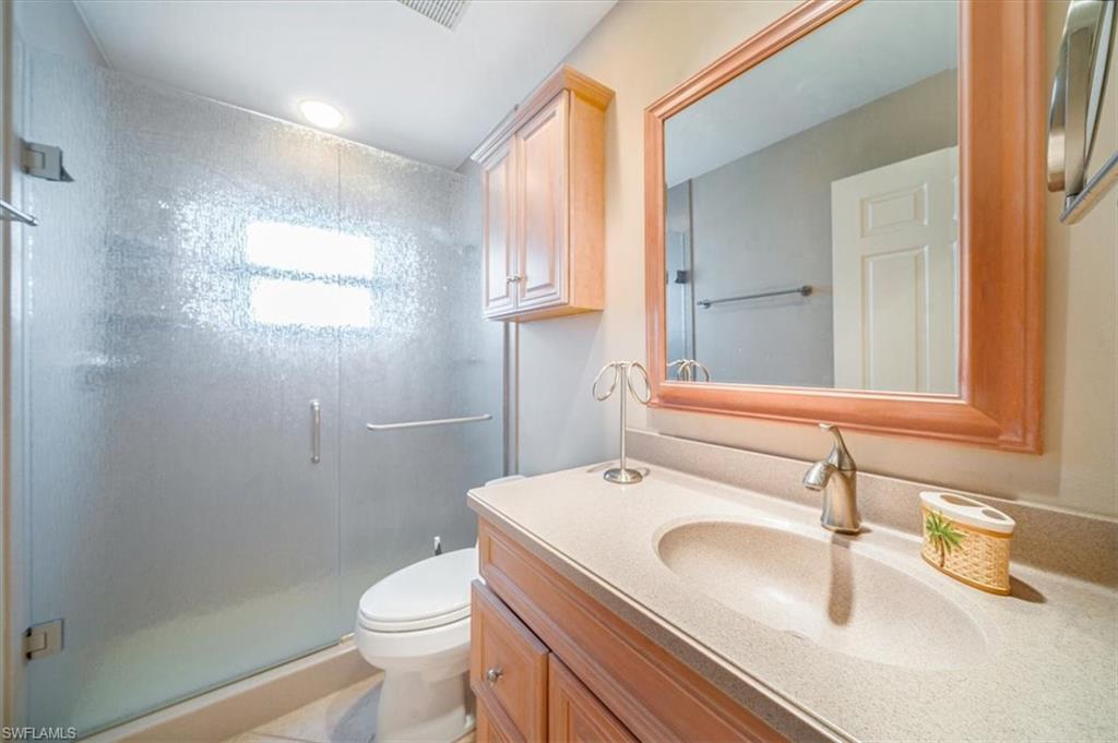 811 Reef Point Circle, Unit 90 Naples, FL 34108 - Photo 22 of 28 a bathroom with a sink a toilet and a mirror
