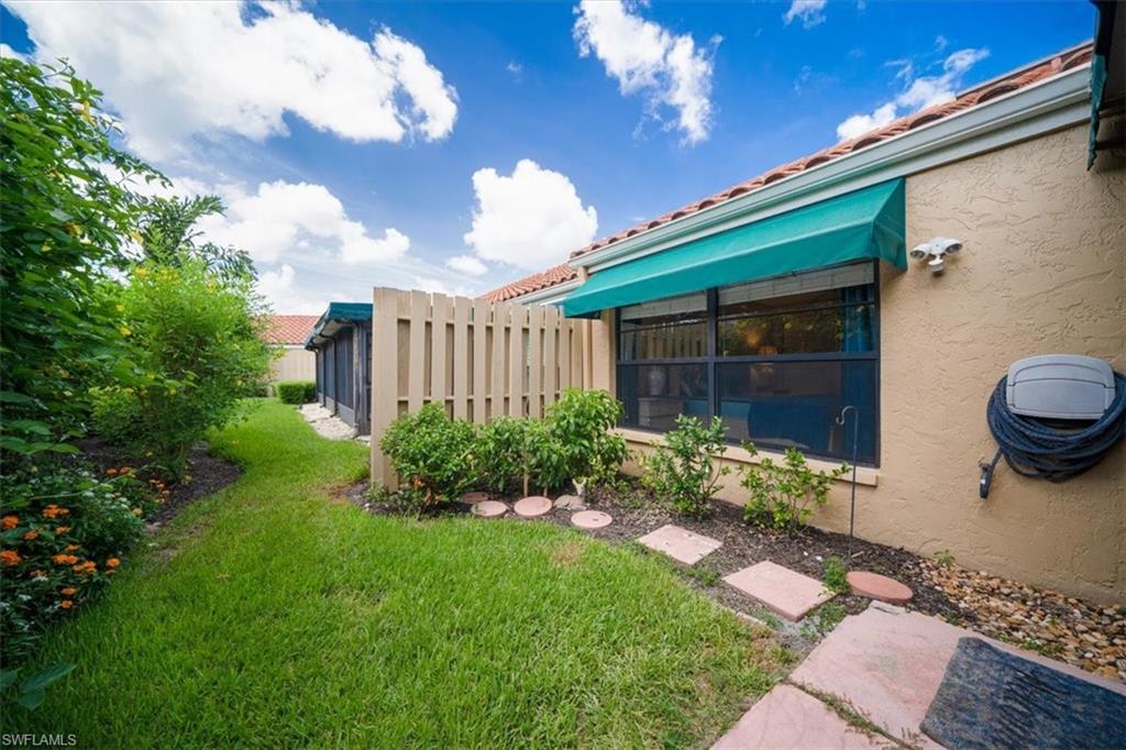 811 Reef Point Circle, Unit 90 Naples, FL 34108 - Photo 24 of 28 a garden view with a seating space