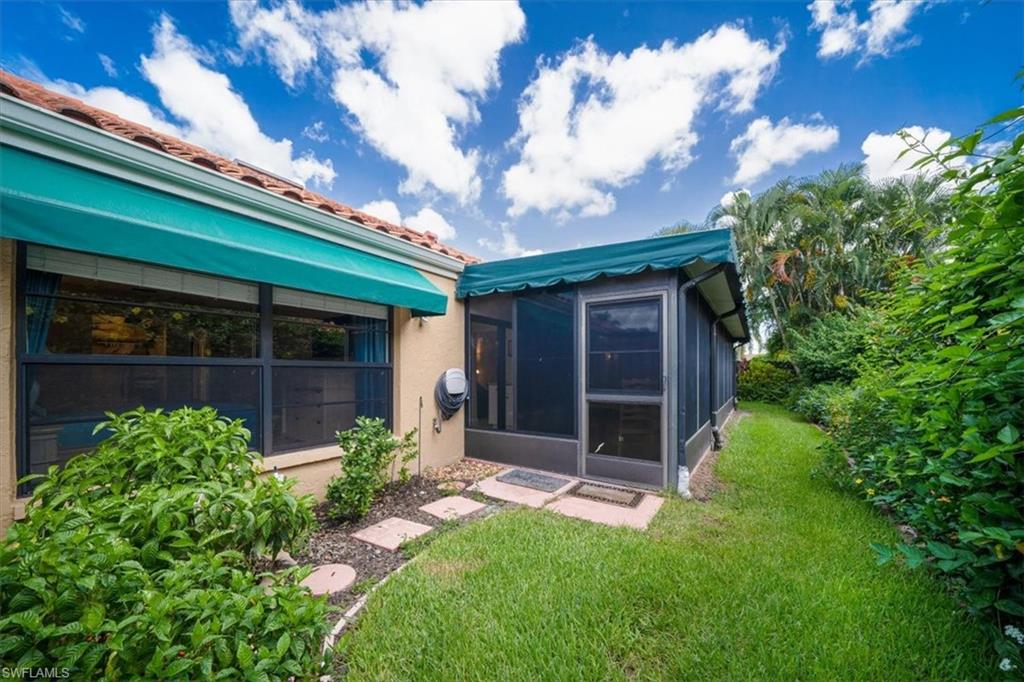 811 Reef Point Circle, Unit 90 Naples, FL 34108 - Photo 25 of 28 a view of a house with a yard and a large tree