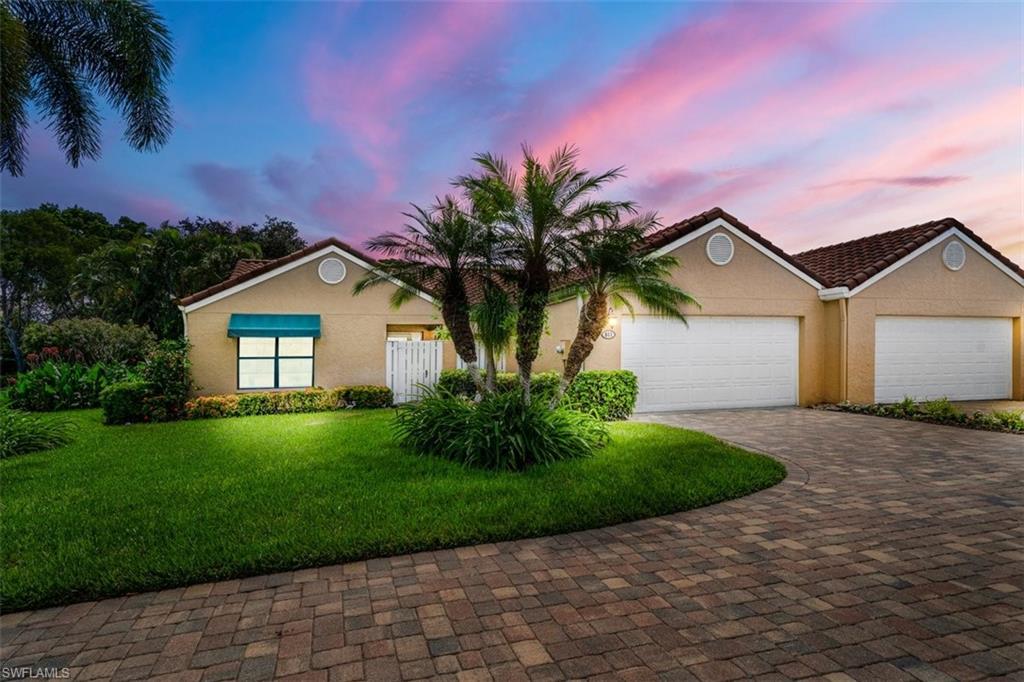 811 Reef Point Circle, Unit 90 Naples, FL 34108 - Photo 28 of 28 a front view of a house with a yard and garage