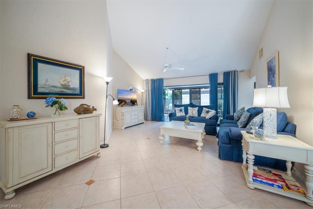 811 Reef Point Circle, Unit 90 Naples, FL 34108 - Photo 3 of 28 a living room with furniture and a flat screen tv