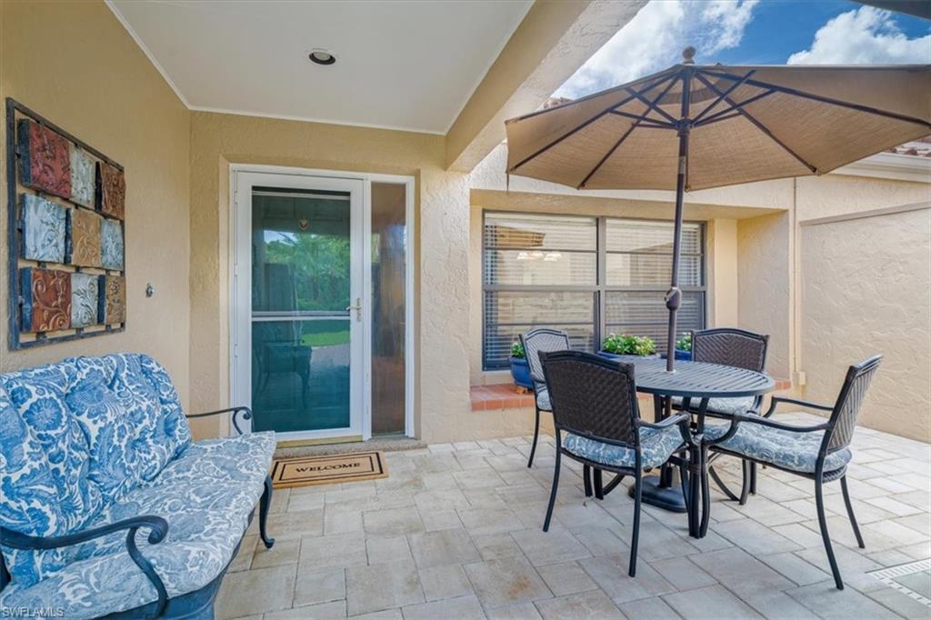 811 Reef Point Circle, Unit 90 Naples, FL 34108 - Photo 8 of 28 a view of a livingroom with furniture and umbrella