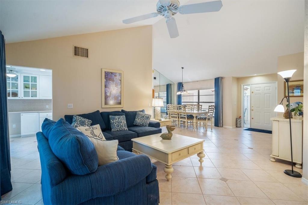 811 Reef Point Circle, Unit 90 Naples, FL 34108 - Photo 9 of 28 a living room with furniture and a table