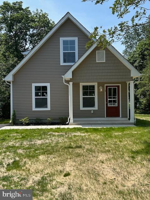 a house that has a large tree in front of it