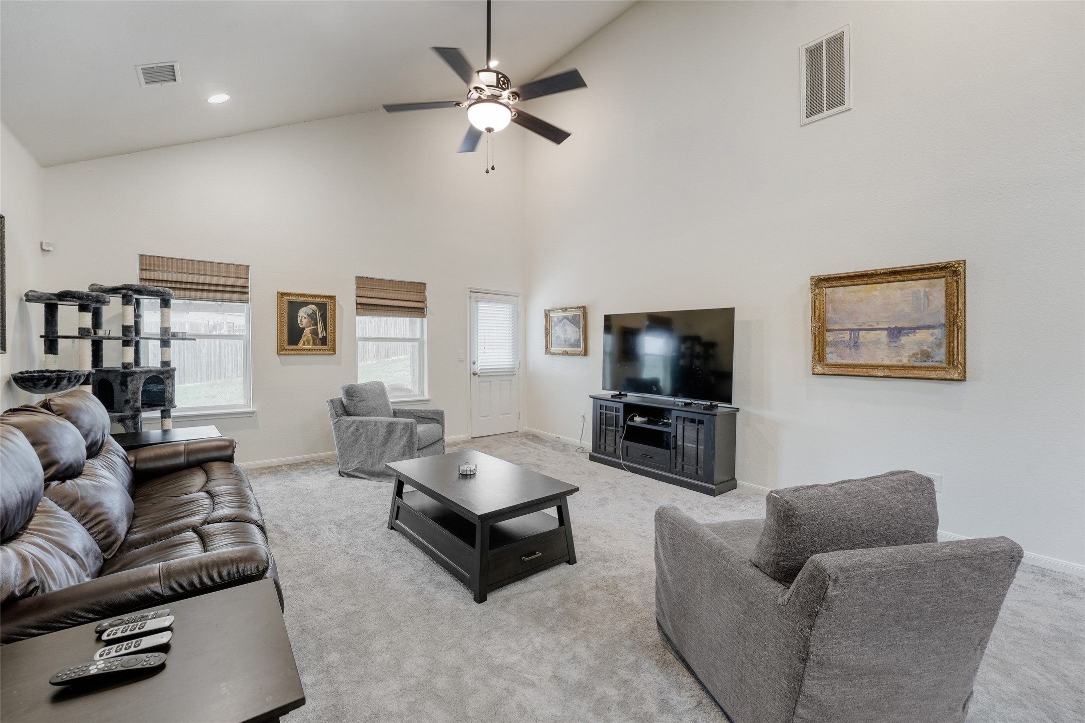 15105 Shell Bark Cove Austin, TX 78724 - Photo 14 of 30 Tall vaulted ceilings and soft gray carpeting create an inviting and open gathering space.