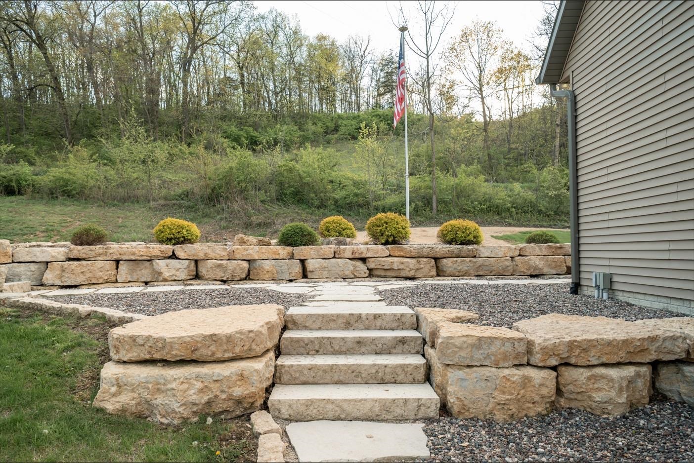 5829 South Pleasant Hill Road Elizabeth, IL 61028 - Photo 29 of 68 a backyard of a house with fountain table and chairs