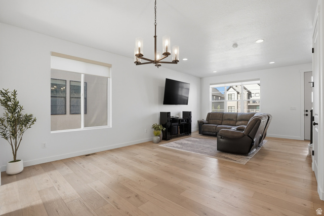 11531 Engelmann Drive Draper, UT 84020 - Photo 7 of 31 Bright living area featuring light wood-finish flooring, recessed lighting, and a modern bronze chandelier