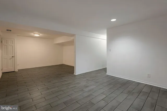 a view of an empty room and wooden floor