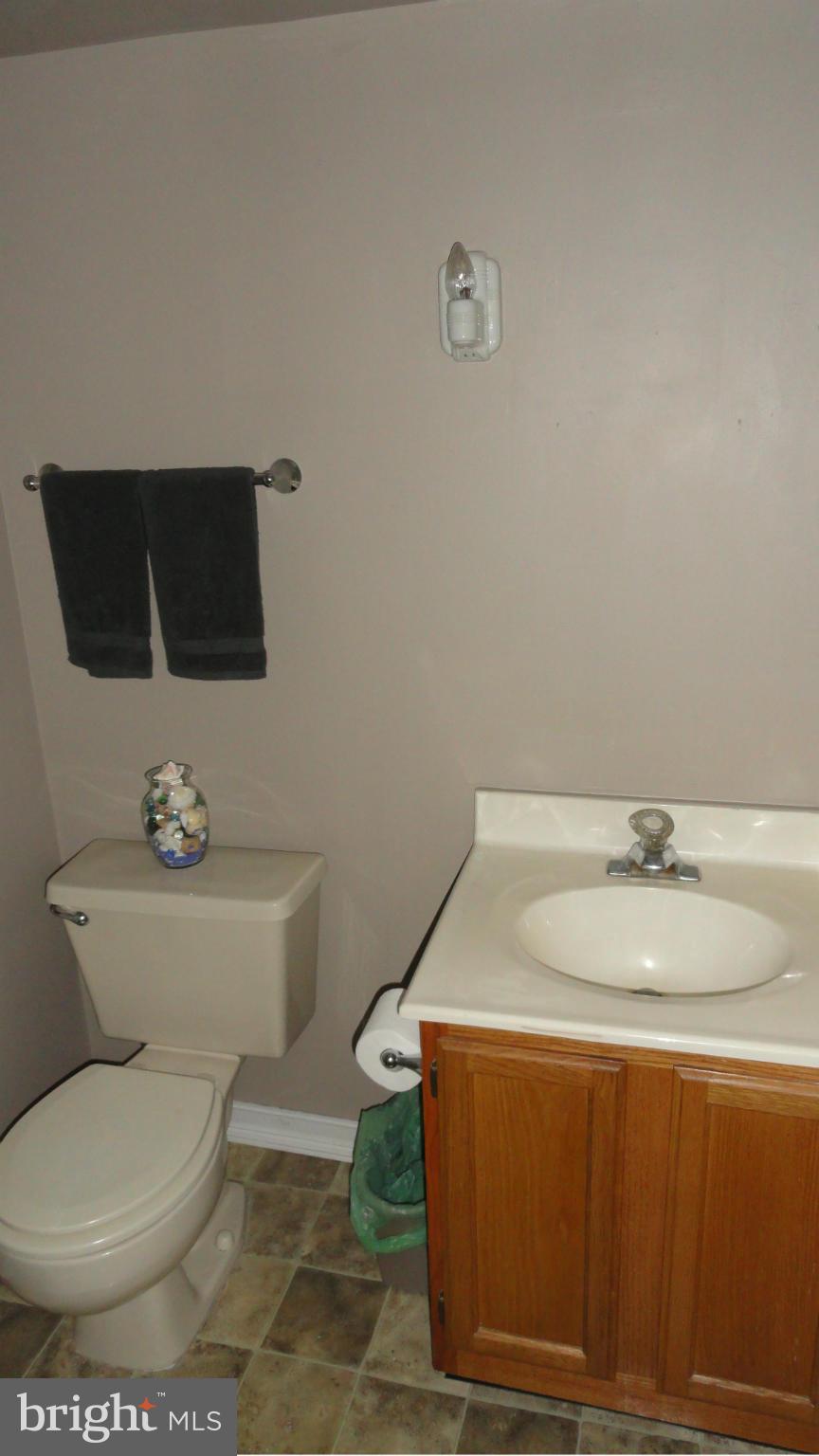 1021 Rodgers Road Churchton, MD 20733 - Photo 12 of 29 a bathroom with a toilet a sink and mirror