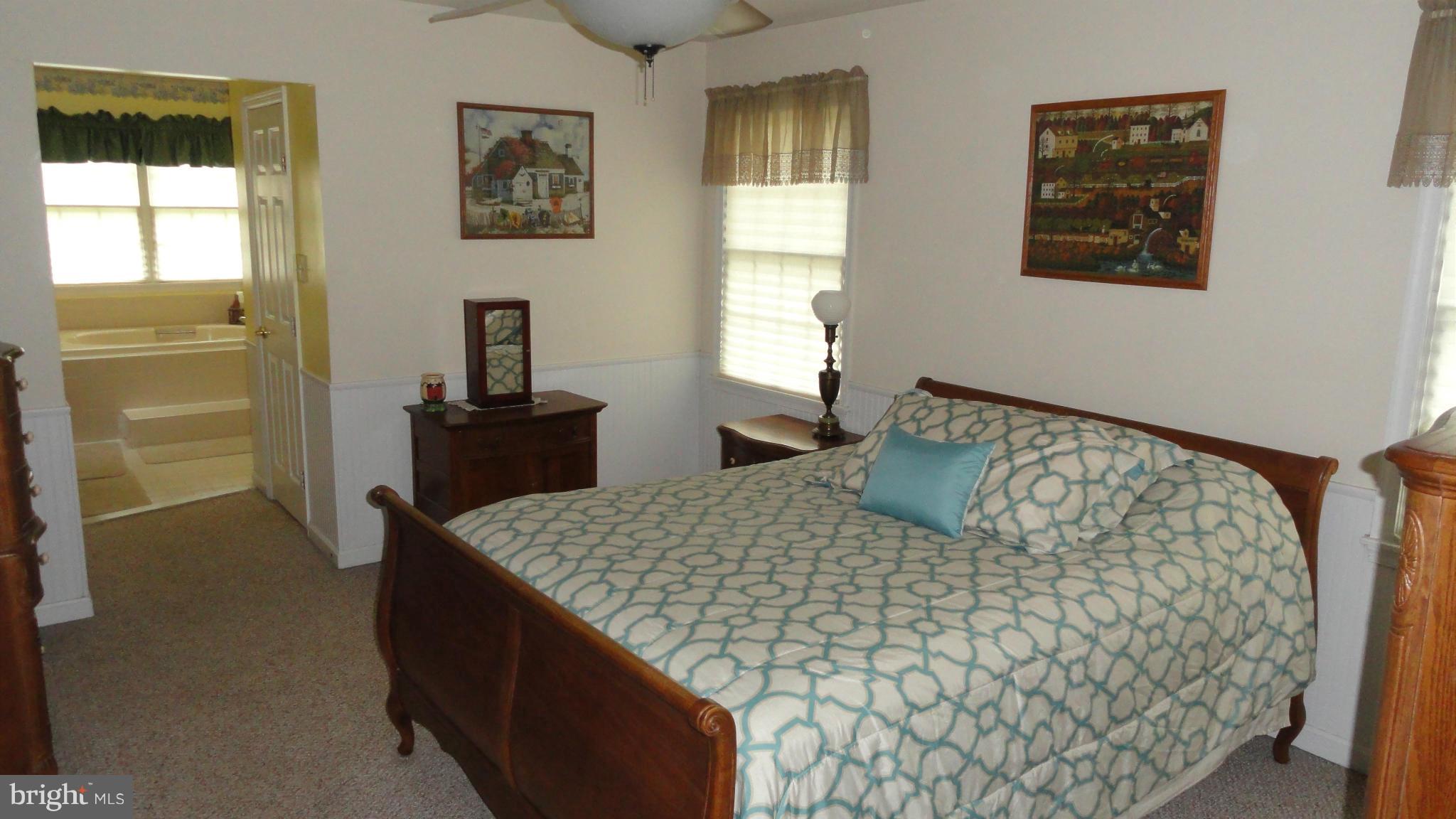 1021 Rodgers Road Churchton, MD 20733 - Photo 19 of 29 a bedroom with a bed and wooden floor