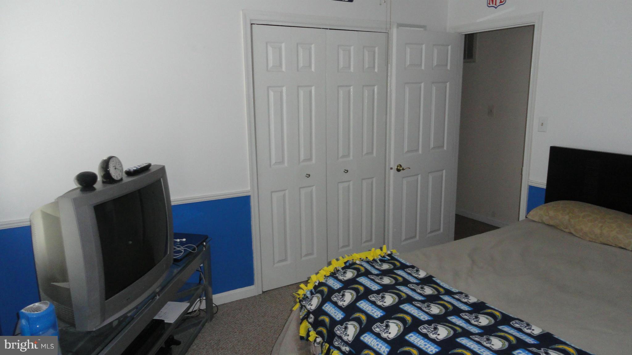 1021 Rodgers Road Churchton, MD 20733 - Photo 24 of 29 a bedroom with a bed and a flat tv screen on a dresser