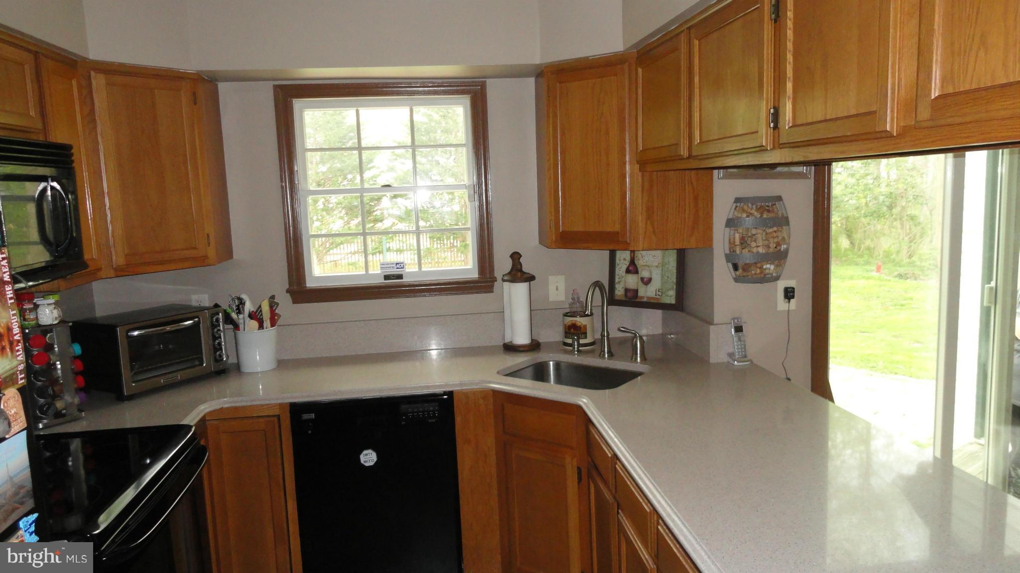 1021 Rodgers Road Churchton, MD 20733 - Photo 7 of 29 a kitchen with stainless steel appliances granite countertop a sink a stove cabinets counter space and a window