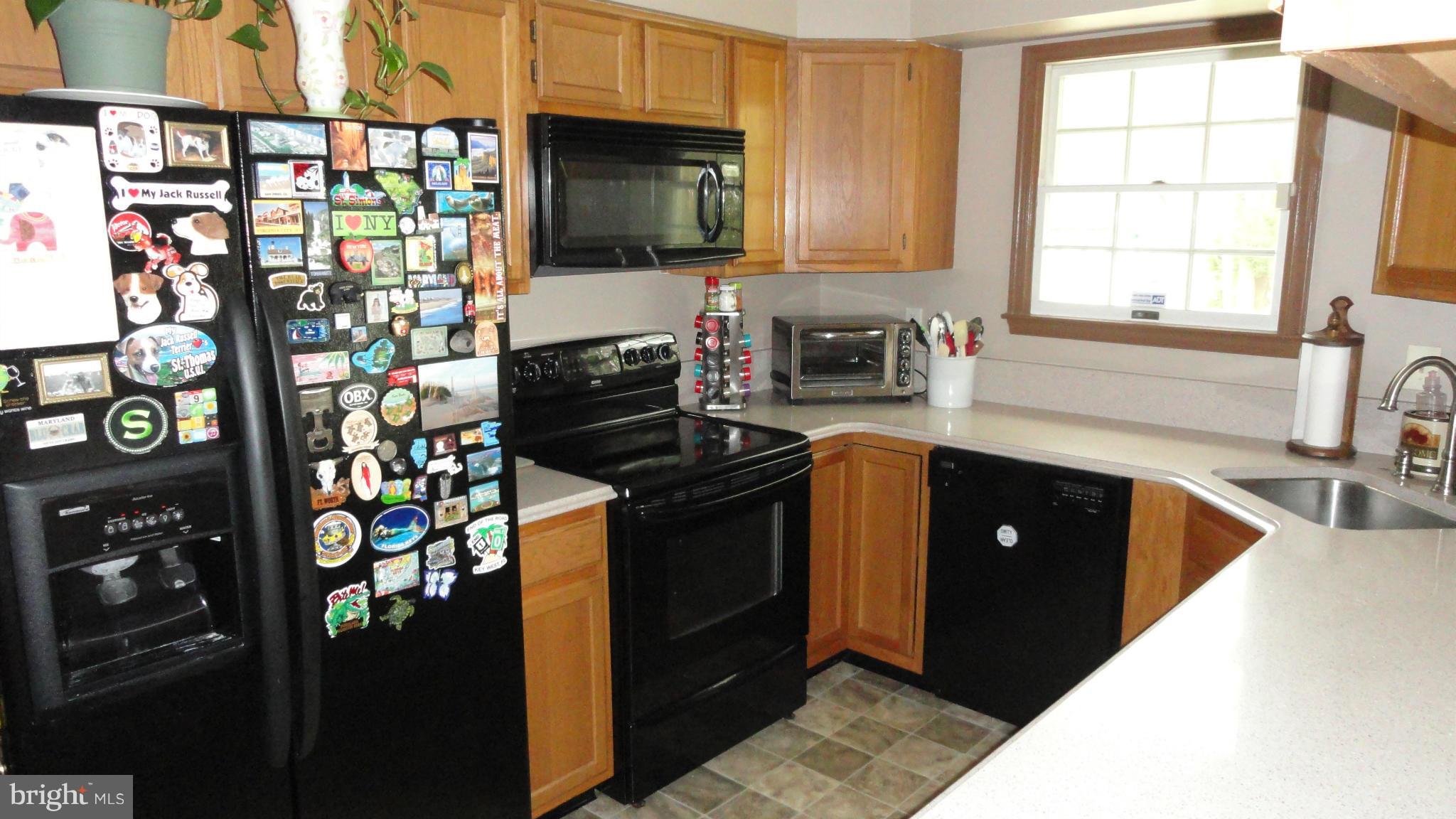 1021 Rodgers Road Churchton, MD 20733 - Photo 8 of 29 a kitchen with stainless steel appliances granite countertop a refrigerator stove and sink